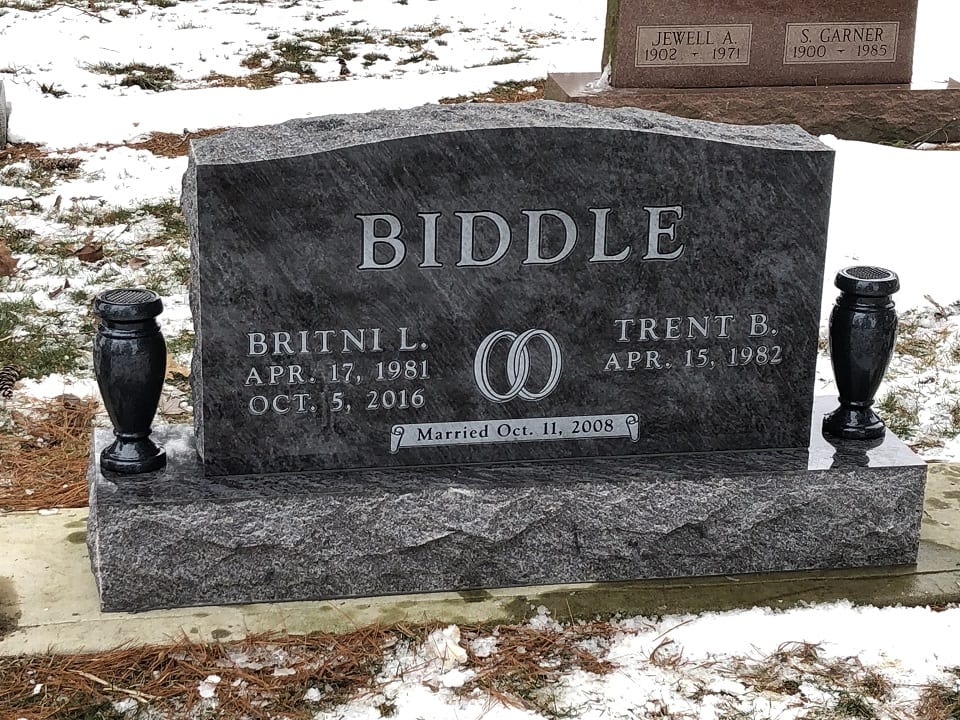 Grey granite companion upright memorial with joined wedding rings, a rock pitched base and two matching granite vases, Crownland Cemetery
