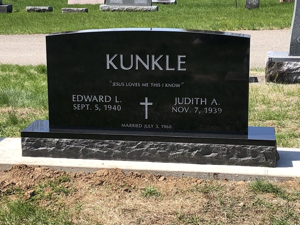 Black granite upright memorial with a rock pitched base, standing in Mount Hope Cemetery, Peru, Indiana