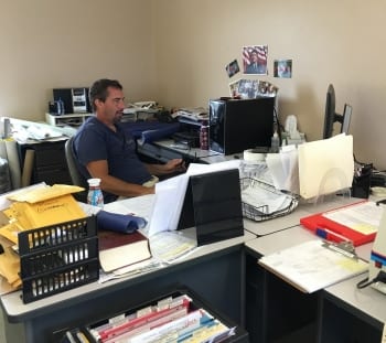 A Caldwell Monument Company designer working at his desk in the Kokomo office