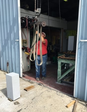 A granite blank waiting beside the hoist at the Kokomo works